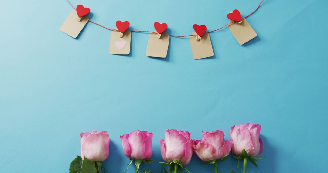 Romantic Valentine Roses with Paper Heart Garland on Blue