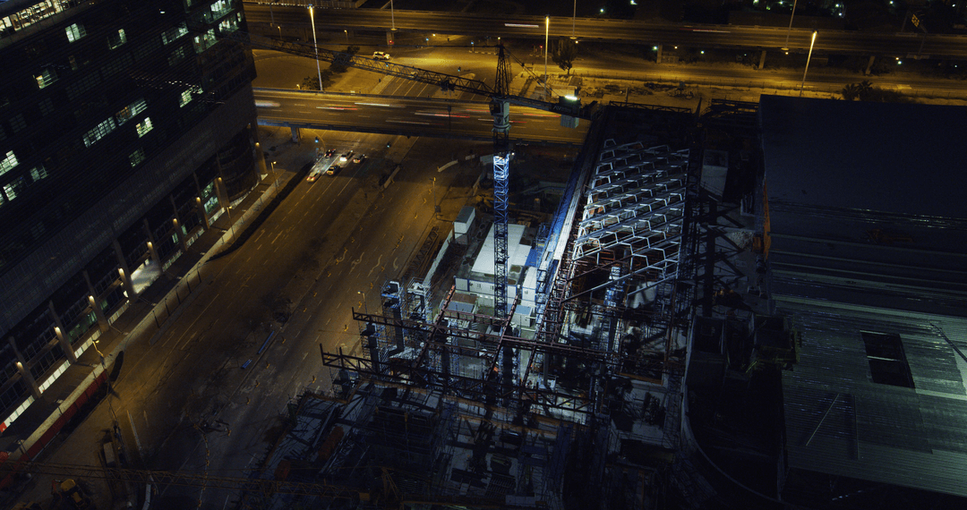 Construction Site Illuminated at Night with Transparent City Lights