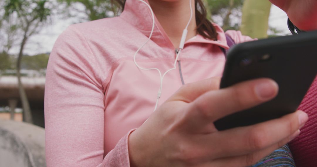 Female Athlete Using Smartphone in Pink Sportswear - Free Images, Stock Photos and Pictures on Pikwizard.com