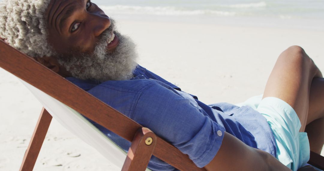 Senior Man Relaxing on Beach Chair at Sunny Seashore - Free Images, Stock Photos and Pictures on Pikwizard.com