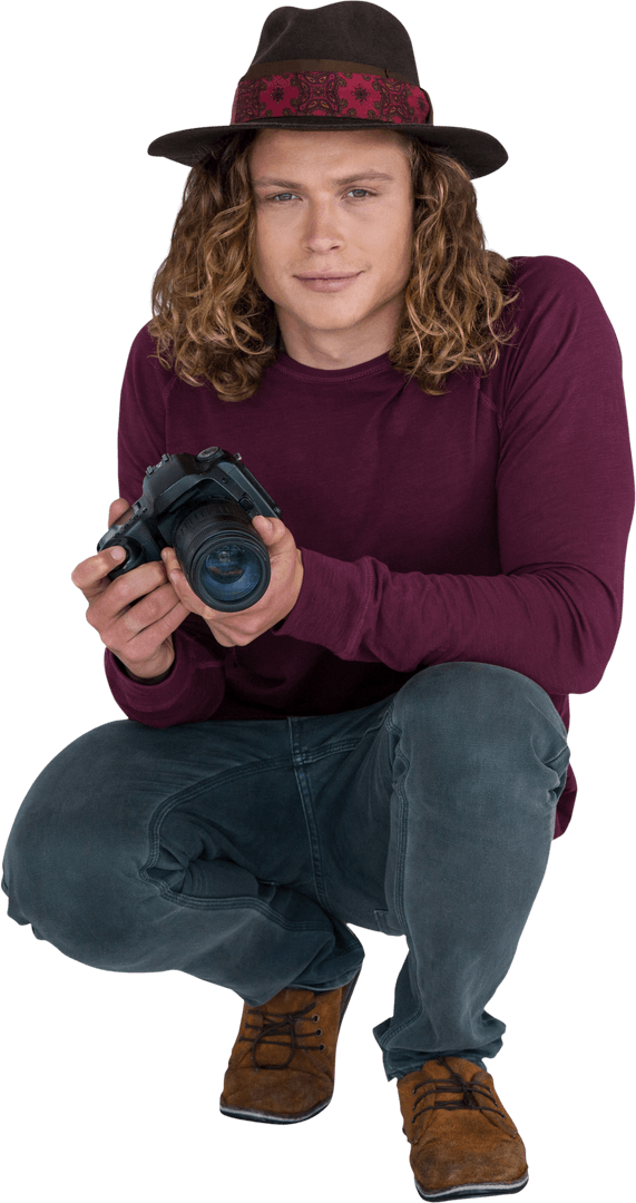 Male Photographer Crouching with Camera and Hat Transparent Background