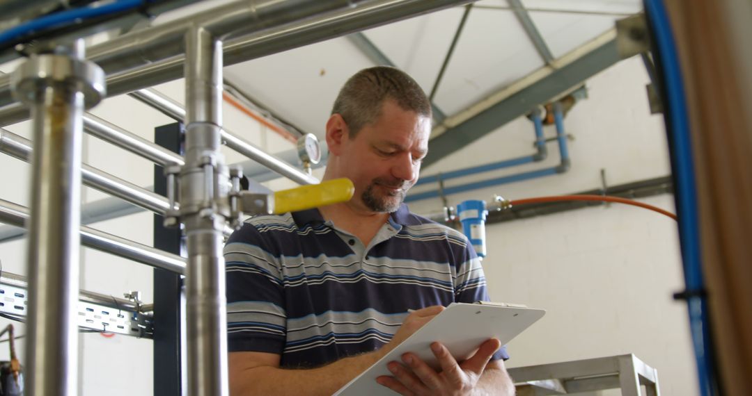 Industrial Engineer Recording Data on Clipboard in Factory - Free Images, Stock Photos and Pictures on Pikwizard.com