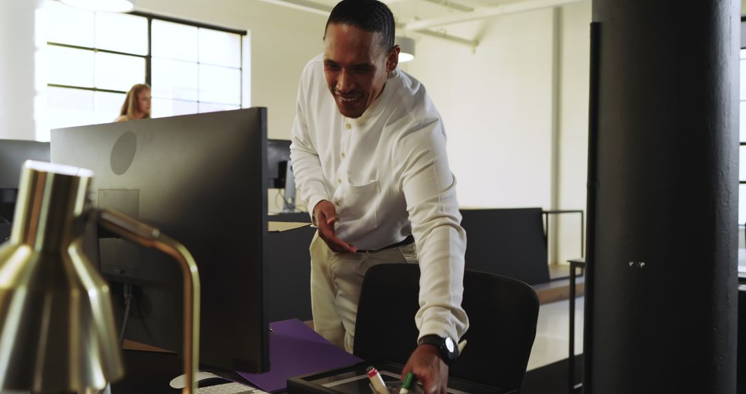 Businessman Organizing Office Desk While Professional Team Collaboration