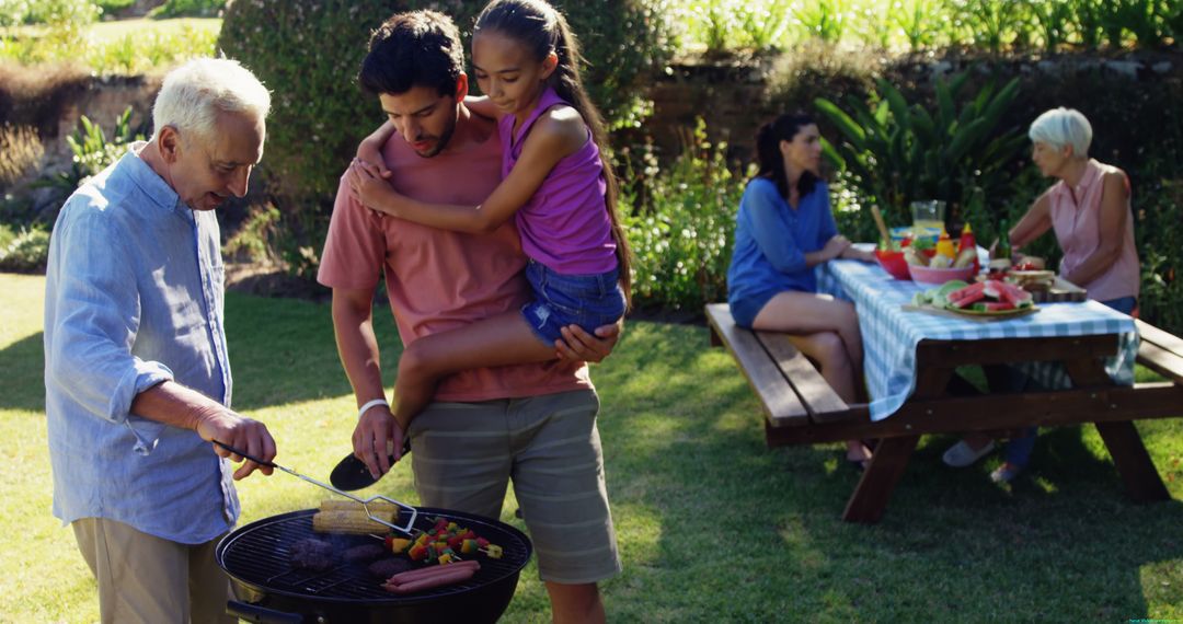 Family Enjoying Barbecue Outdoors on Sunny Day - Free Images, Stock Photos and Pictures on Pikwizard.com