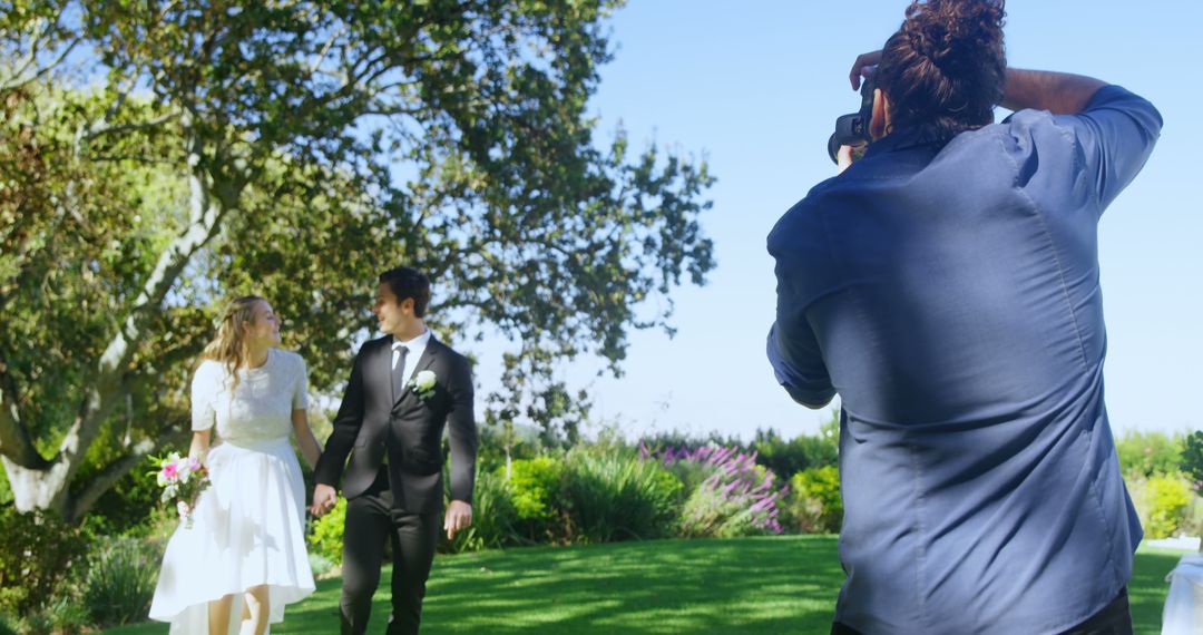 Wedding Photographer Capturing Newlywed Couple Outdoors - Free Images, Stock Photos and Pictures on Pikwizard.com