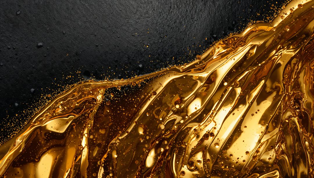 Flowing Liquid Gold Creating Glossy Ribbons, Droplets and Micro-Splatter on Matte Black