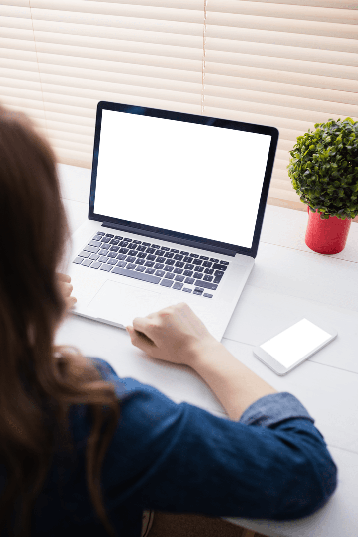 Woman Working at Desk with Laptop and Smartphone Screens Blank