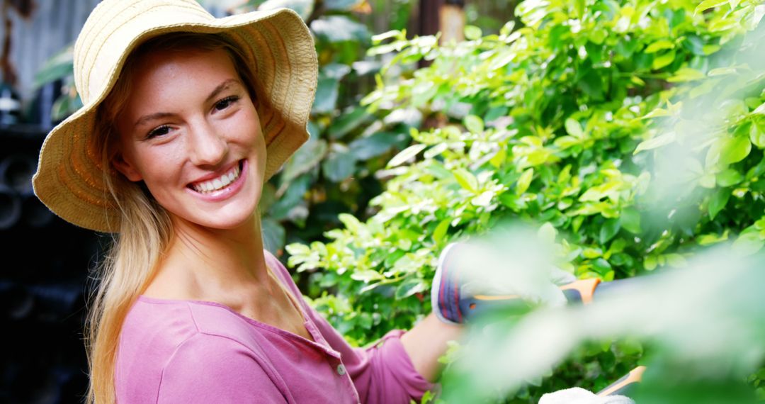 Smiling Young Woman Gardening Outdoors on a Sunny Day - Free Images, Stock Photos and Pictures on Pikwizard.com