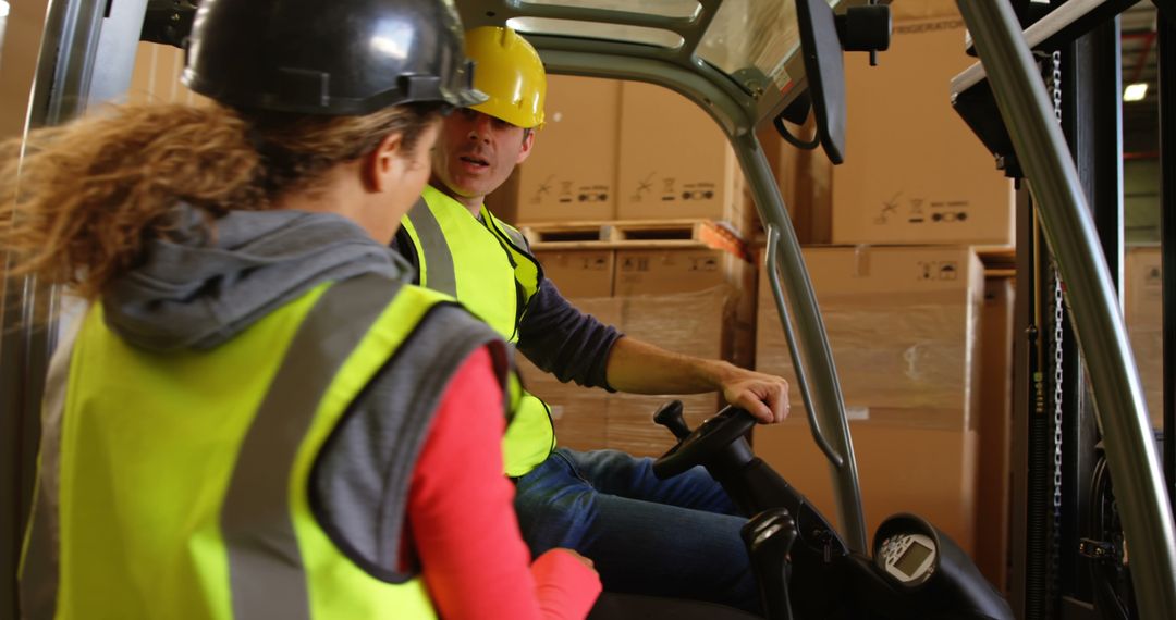 Warehouse Workers Operating Forklift and Communicating - Free Images, Stock Photos and Pictures on Pikwizard.com