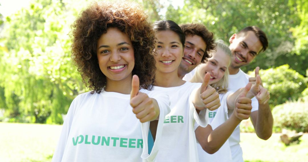 Diverse Group of Happy Volunteers Giving Thumbs Up in Park - Free Images, Stock Photos and Pictures on Pikwizard.com