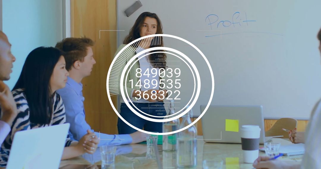 Diverse Team Analyzing Data with Innovative Technology in Office