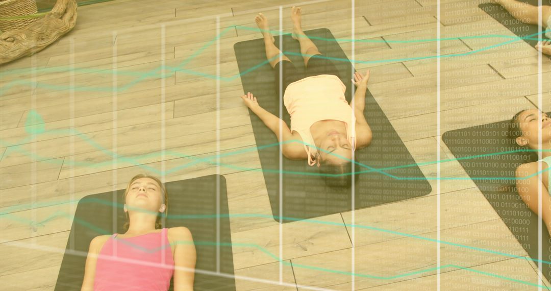 Group Practicing Supine Restorative Yoga on Mats for Deep Relaxation and Mindfulness in Studio