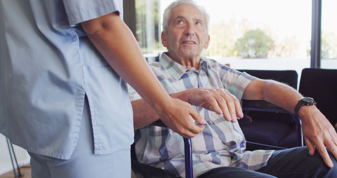 Elderly Man Receiving Assistance from Nurse in Living Room - Free Images, Stock Photos and Pictures on Pikwizard.com