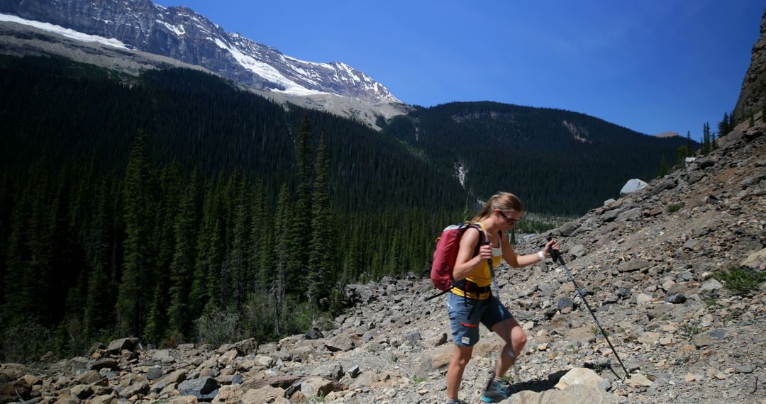 Female Hiker with Backpack Climbing Rocky Mountain Trail on Sunny Day - Free Images, Stock Photos and Pictures on Pikwizard.com