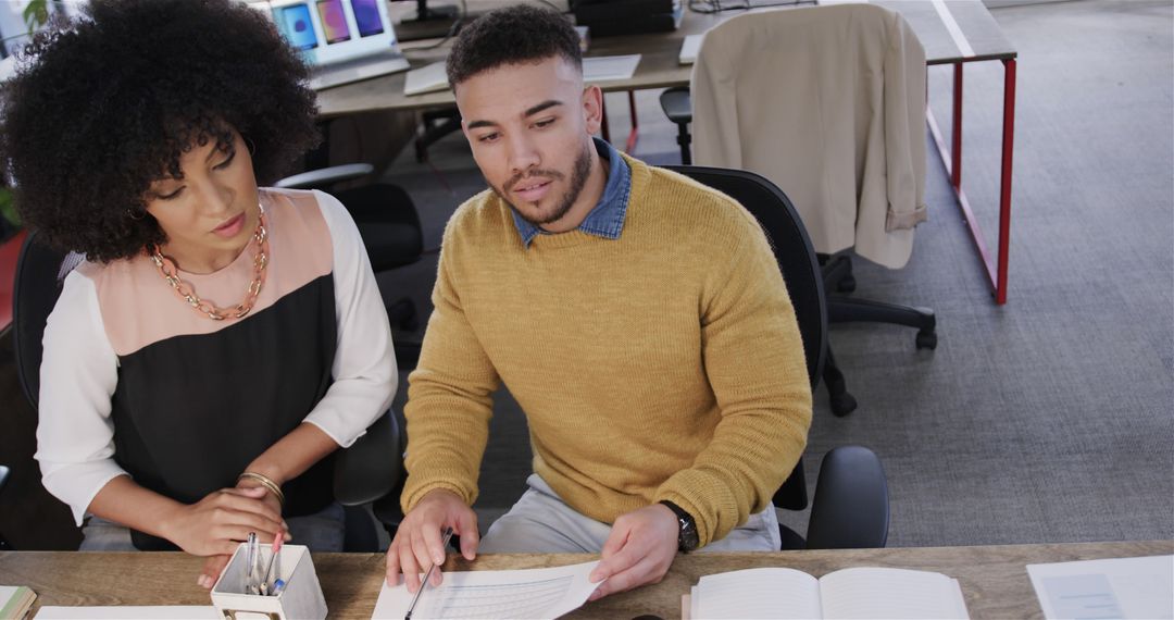Colleagues Collaborating at Office Desk In Casual Meeting