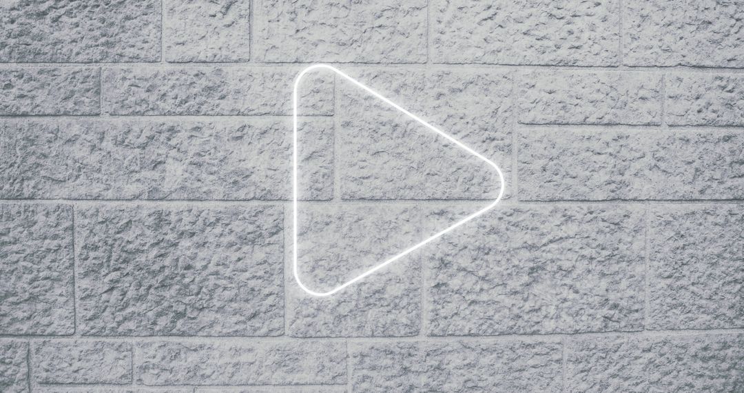 Neon Arrow Icon on Brick Wall Signifying Digital Interface