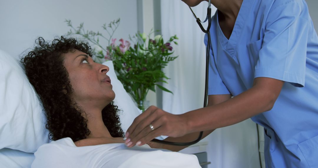 Nurse Checking Heartbeat of African-American Woman in Hospital Bed - Free Images, Stock Photos and Pictures on Pikwizard.com