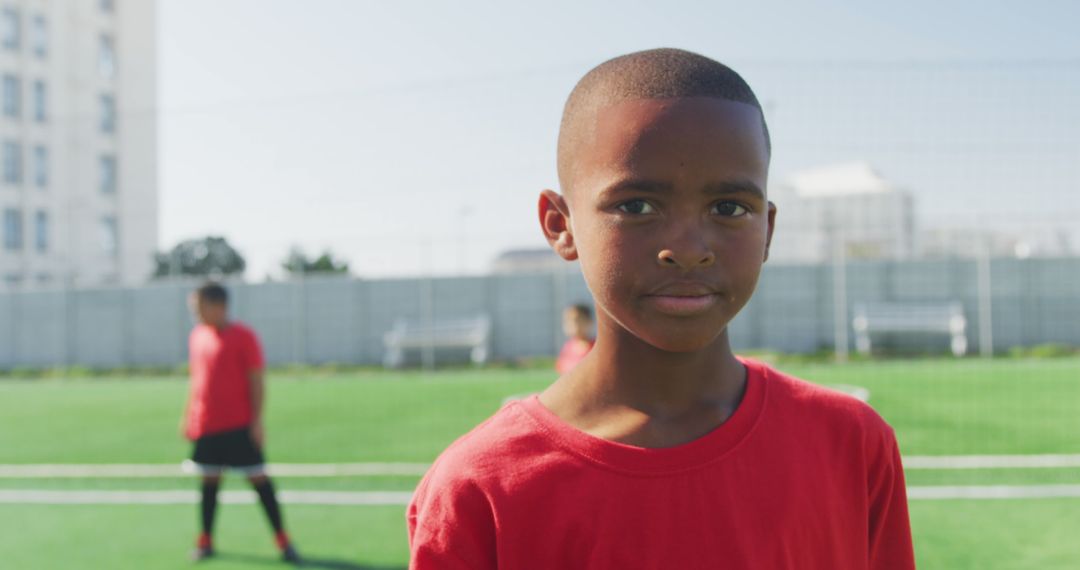 Young Boy in Red Jersey Standing on Soccer Field - Free Images, Stock Photos and Pictures on Pikwizard.com