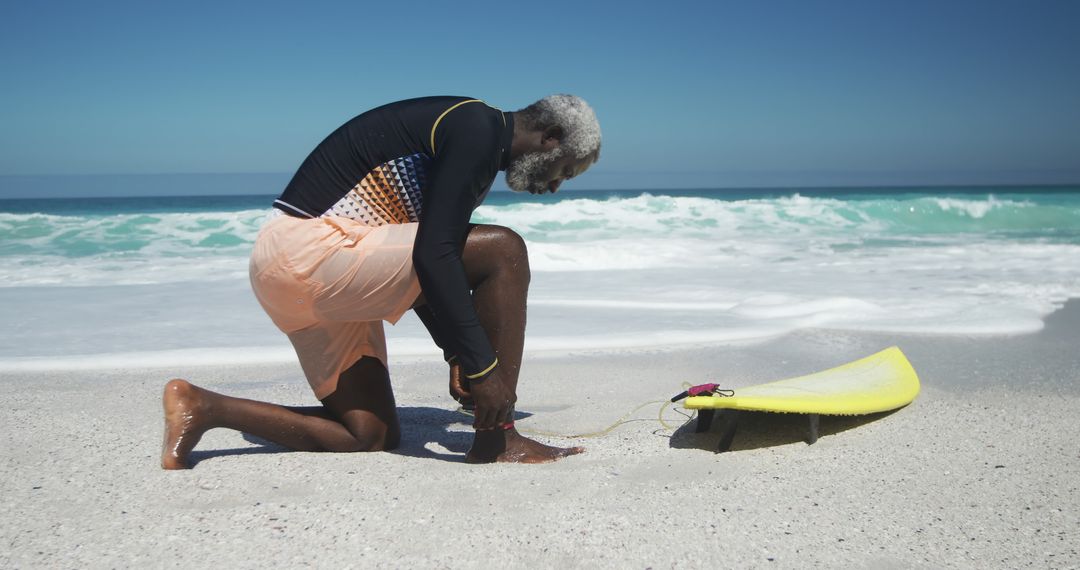 Senior Surfer Preparing Surfboard on Tropical Beach - Free Images, Stock Photos and Pictures on Pikwizard.com