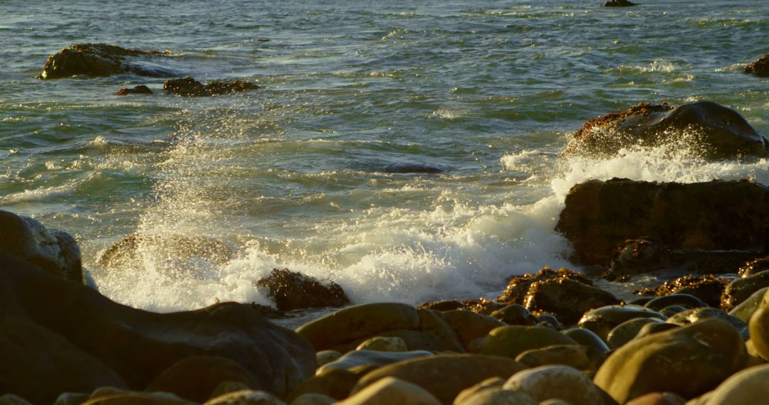 Waves Crashing on Rocky Shore at Sunset - Free Images, Stock Photos and Pictures on Pikwizard.com