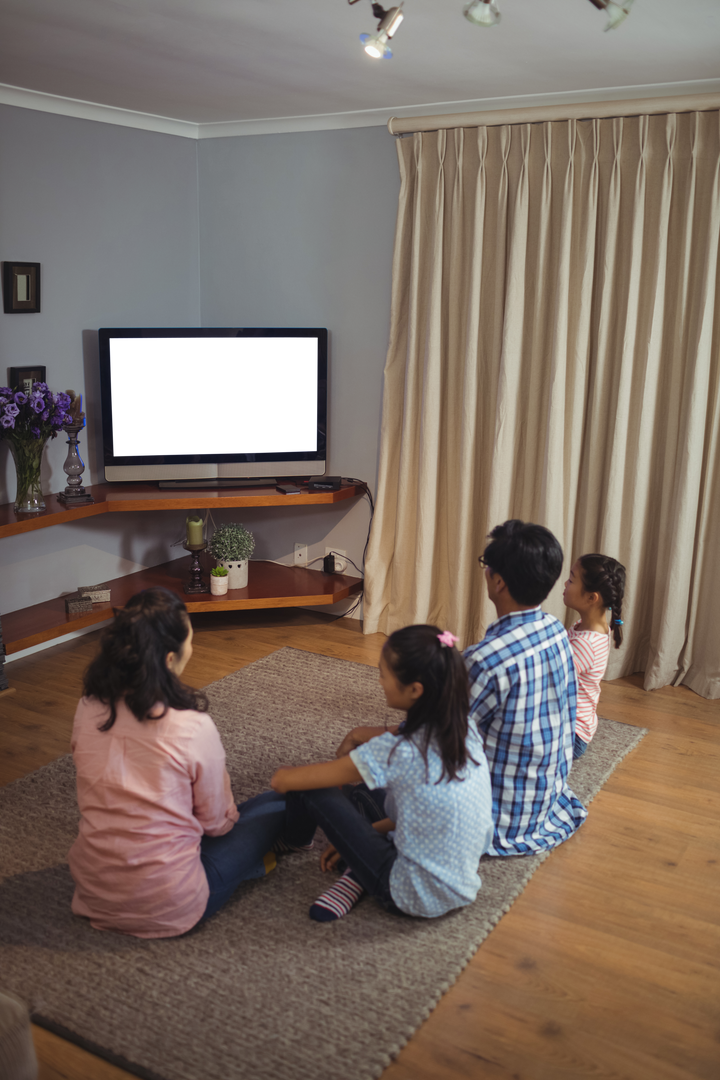 Asian Family Watching Television Together in Cozy Living Room - Download Free Stock Images Pikwizard.com