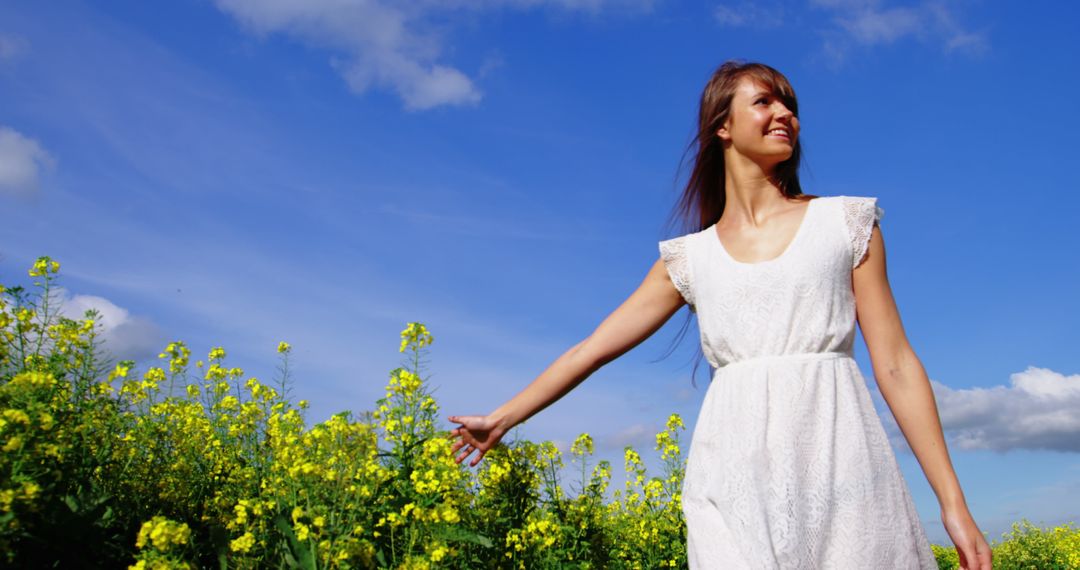 Woman Enjoying Sunny Day in Mustard Field - Free Images, Stock Photos and Pictures on Pikwizard.com