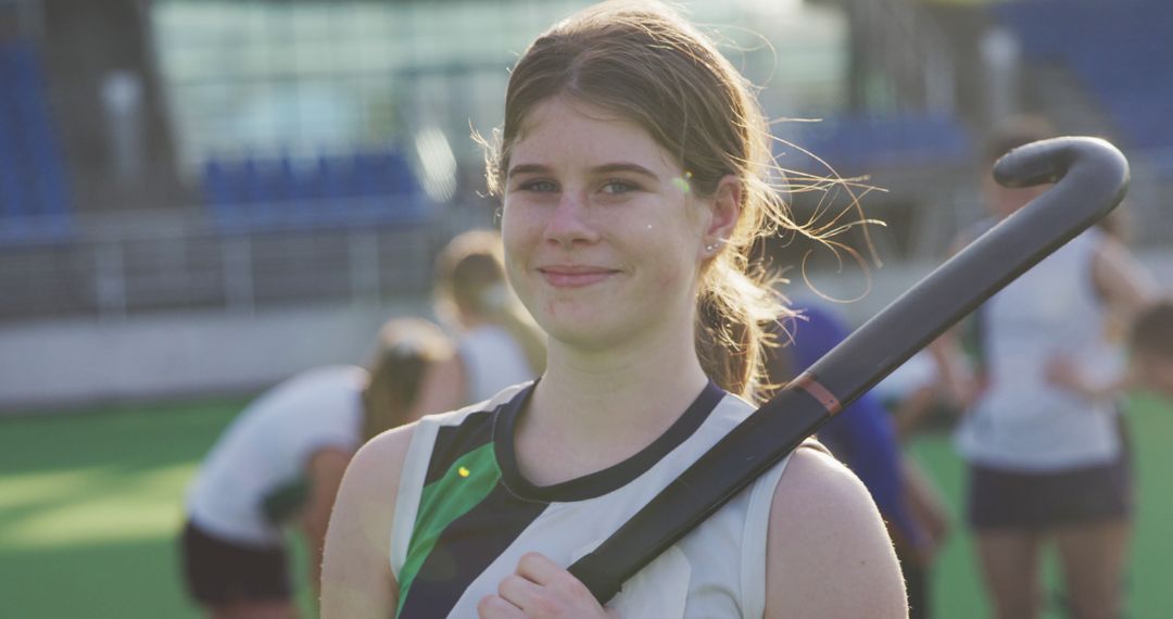 Young Female Field Hockey Player Standing Proudly with Stick - Free Images, Stock Photos and Pictures on Pikwizard.com