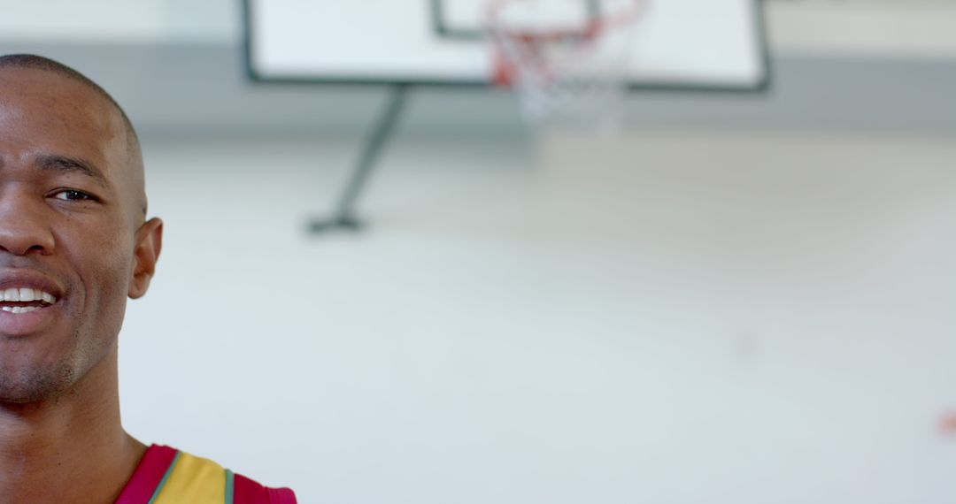 Confident Basketball Player Standing in Indoor Court, From Smiling Profile View