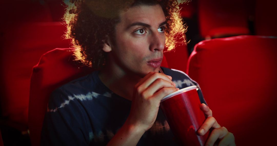 Man Relaxing with Large Red Drink in Cinematic Environment - Free Images, Stock Photos and Pictures on Pikwizard.com