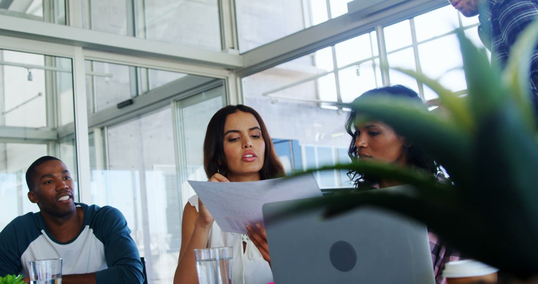 Diverse Team Collaborating in Modern Office Discussing Ideas