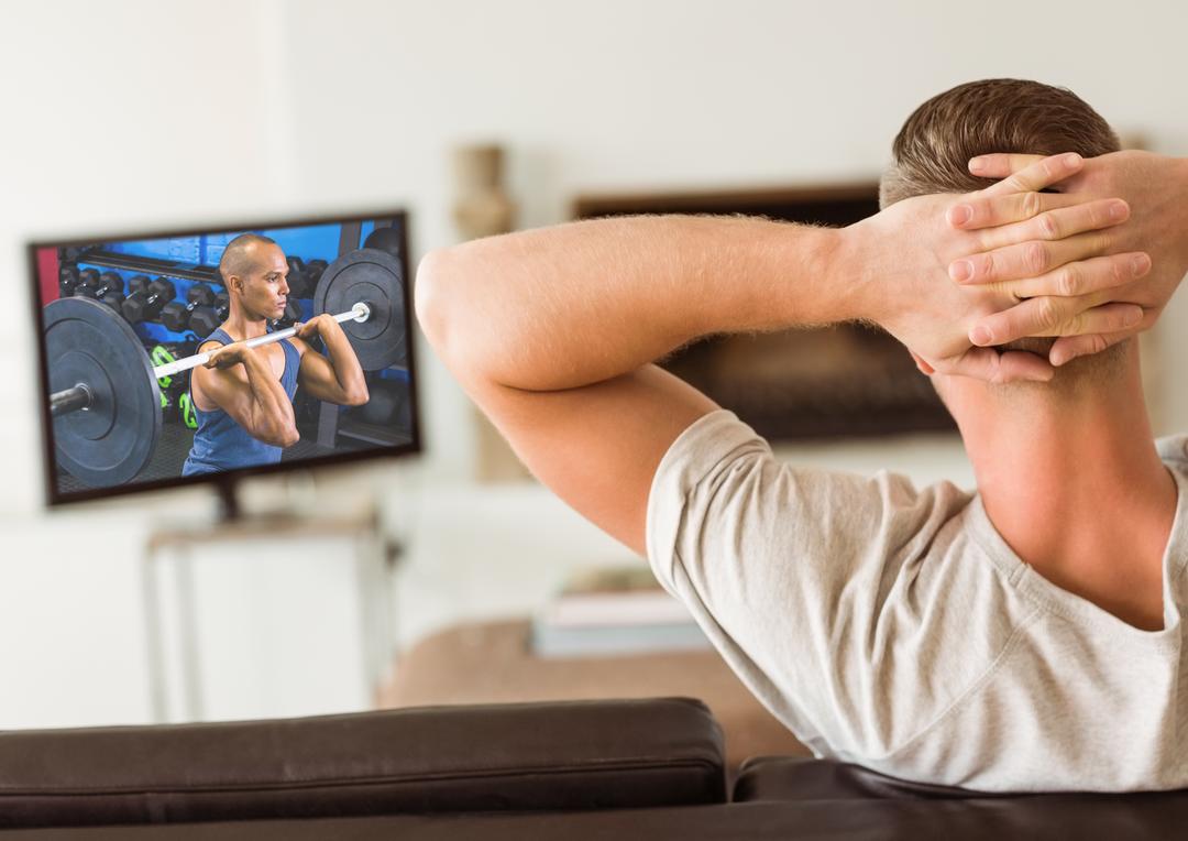 Man watching weightlifting competition on TV - Free Images, Stock Photos and Pictures on Pikwizard.com