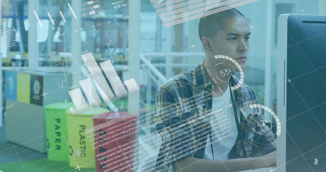 Analyzing data dashboards on desktop while recycling bins visible in open-plan office
