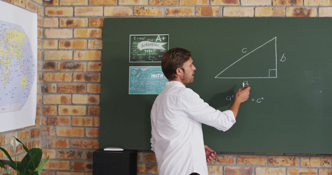 Male Teacher Drawing Triangle on Chalkboard in Classroom - Free Images, Stock Photos and Pictures on Pikwizard.com