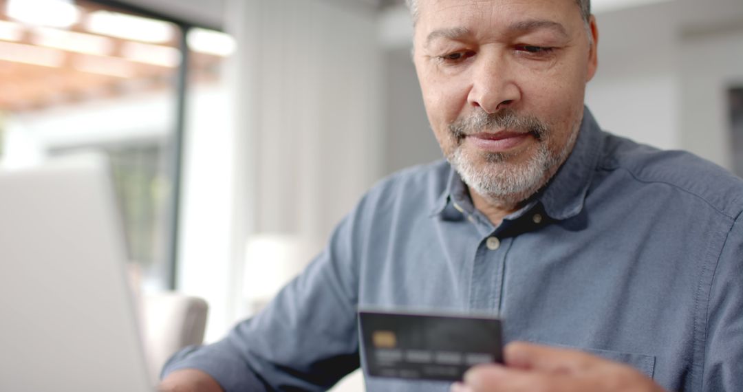 Middle-aged man shopping online with credit card and laptop - Free Images, Stock Photos and Pictures on Pikwizard.com