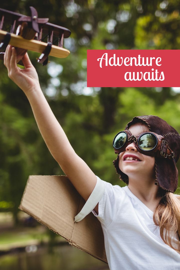 Child Imagining Flight Holding Model Plane Outdoors