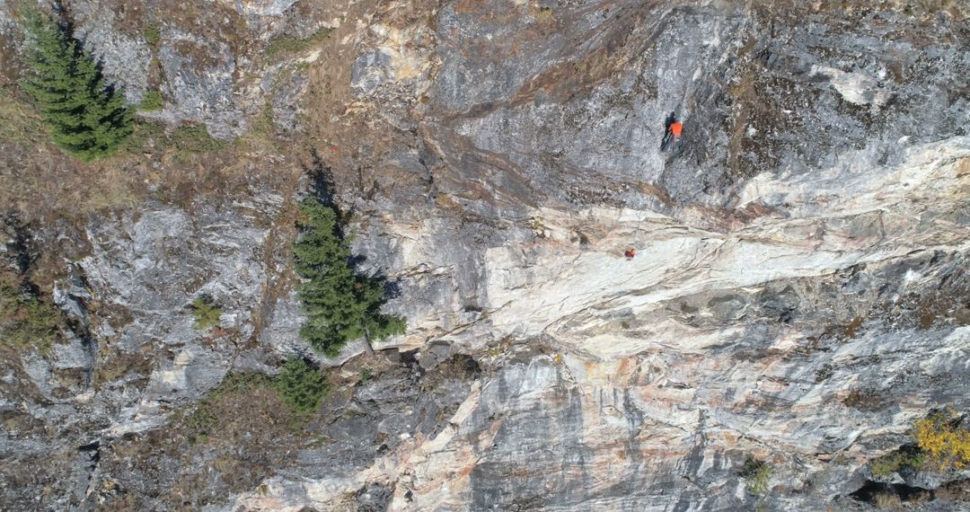 Aerial View of Rock Climber on Rugged Mountain Cliff - Free Images, Stock Photos and Pictures on Pikwizard.com