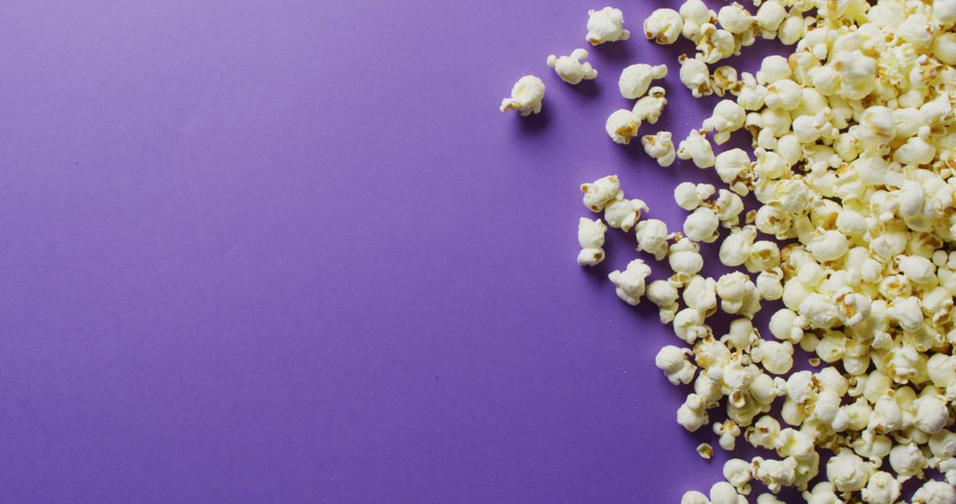 Close-up of Popcorn Scattered on Purple Background