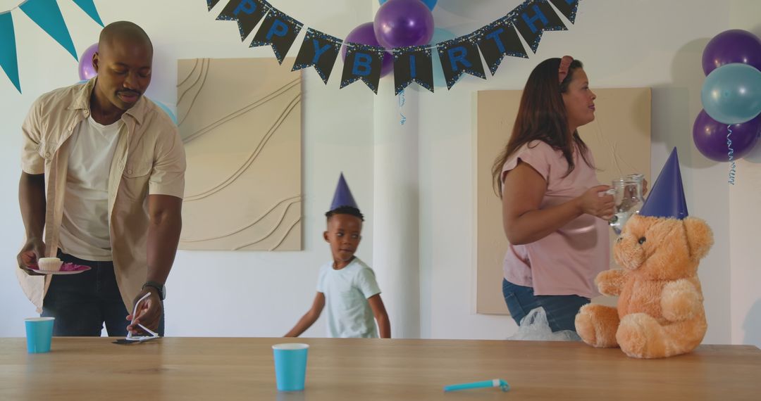 Diverse Family Preparing Birthday Table with Decorations and Cake