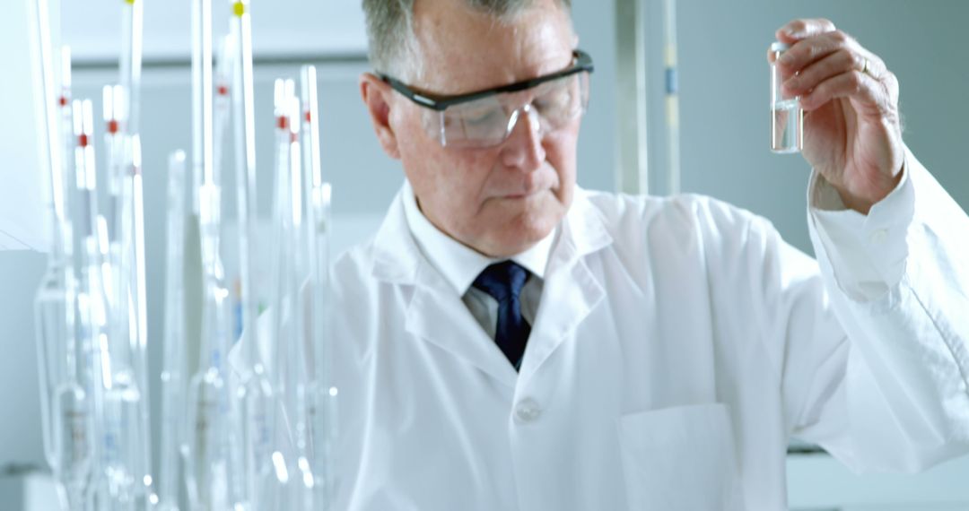 Senior Scientist Analyzing Lab Sample Wearing Safety Glasses - Free Images, Stock Photos and Pictures on Pikwizard.com