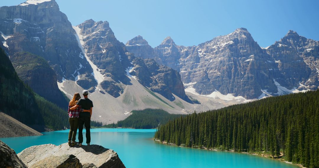 Couple Enjoying Scenic Mountain View at Lake Louise, Canada - Free Images, Stock Photos and Pictures on Pikwizard.com