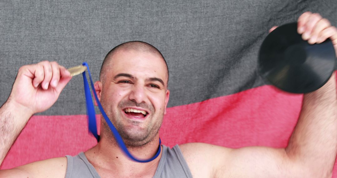 Male Athlete Celebrating Victory with Medal and Discus - Free Images, Stock Photos and Pictures on Pikwizard.com