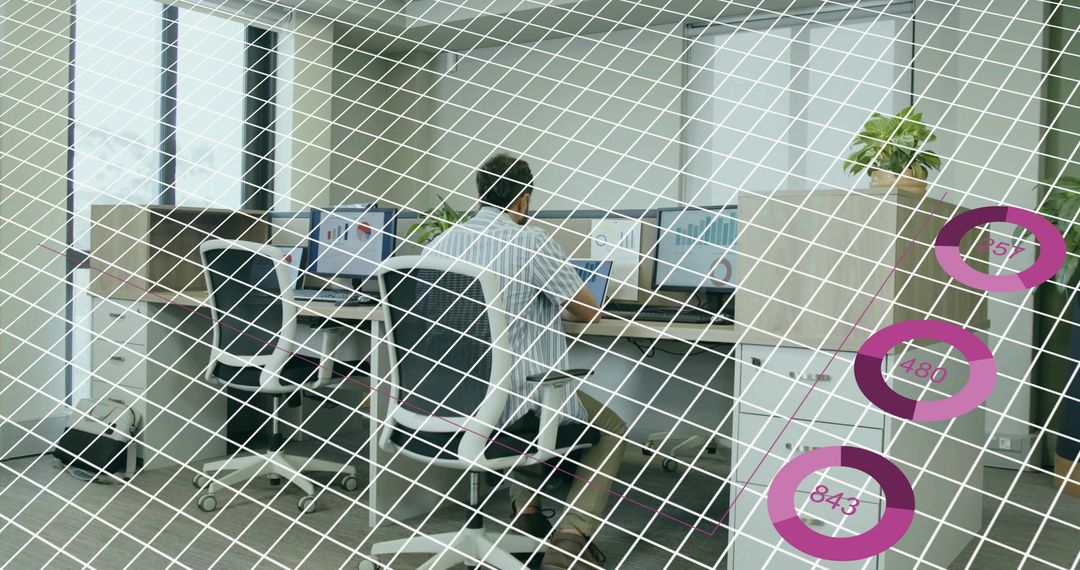 Office Worker Monitoring Multiple Screens with Digital Overlay