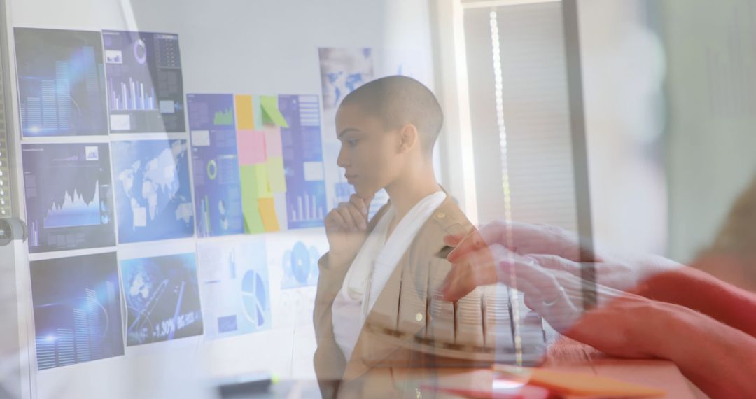 Businesswoman Analyzing Data on Glass Wall and Overlaid Computer Usage