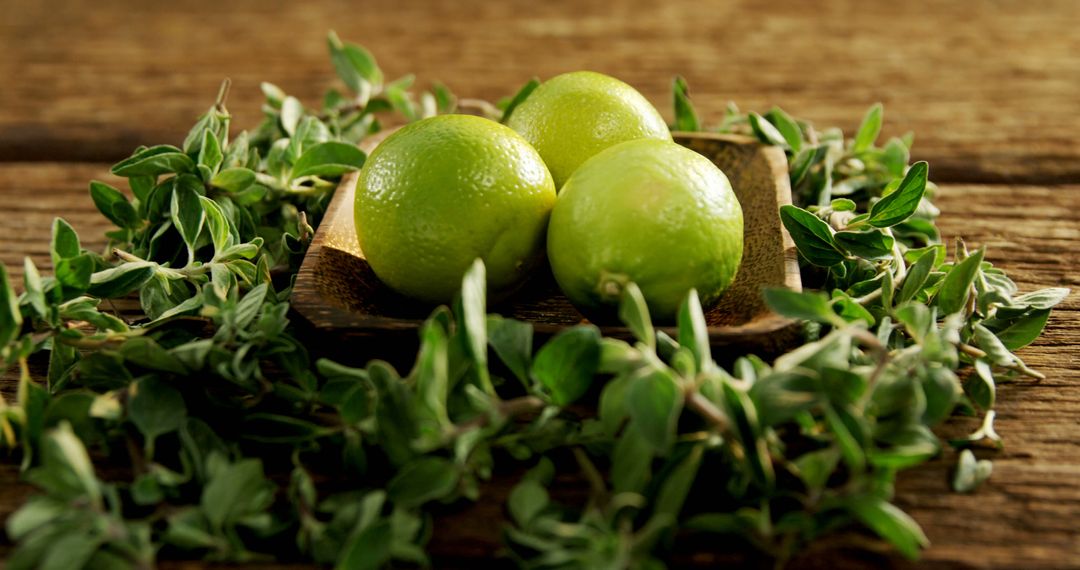 Fresh Limes on Wooden Tray Surrounded by Herbs - Free Images, Stock Photos and Pictures on Pikwizard.com