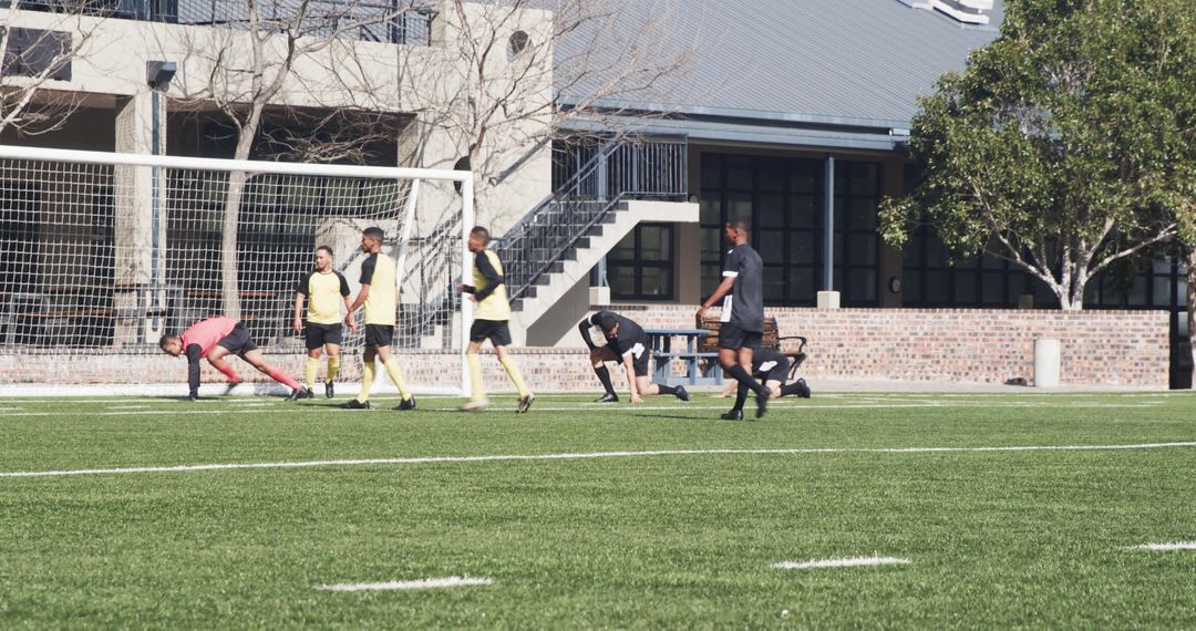 Athletes Practicing Soccer on Field for Team Strategy