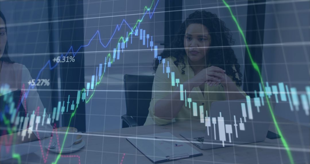 Businesswomen Discussing Stock Market Data with Graph Overlay - Free Images, Stock Photos and Pictures on Pikwizard.com