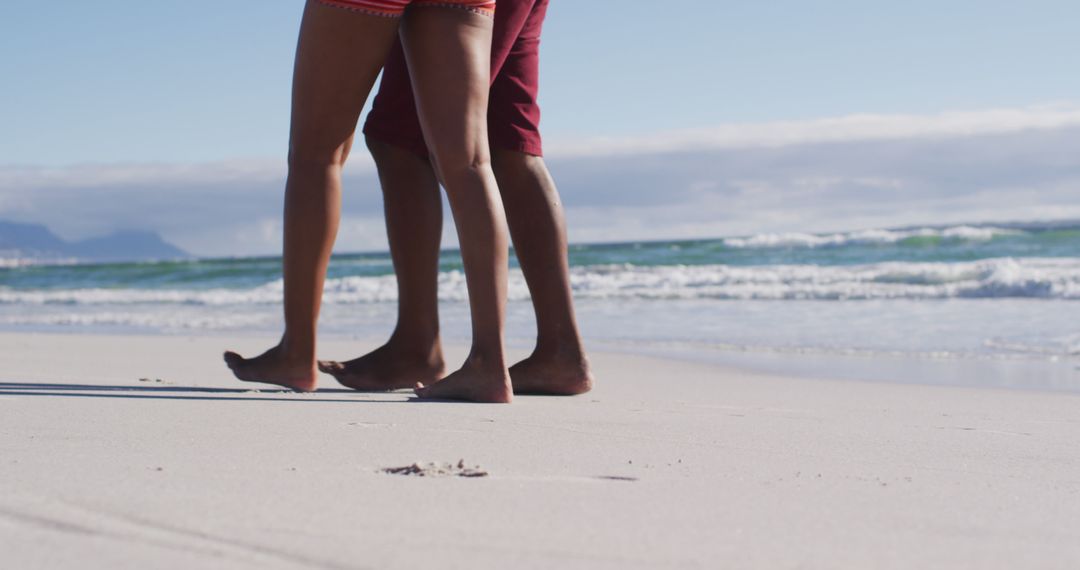 Couple Walking Barefoot on Sandy Beach - Free Images, Stock Photos and Pictures on Pikwizard.com