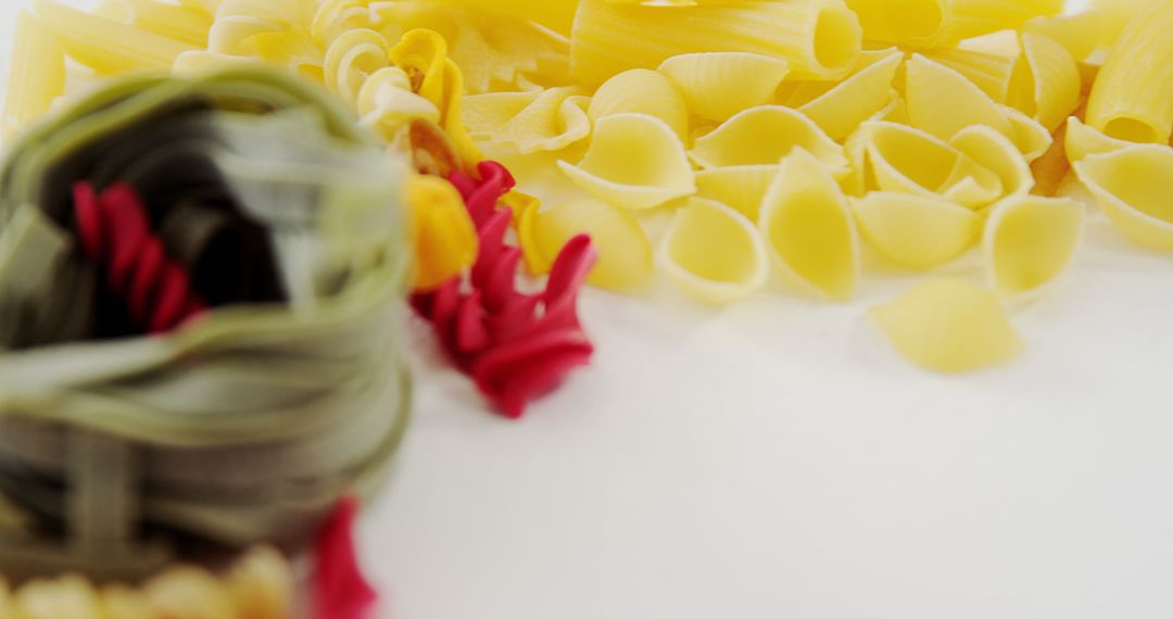 Variety of Colorful Uncooked Pasta on White Background - Free Images, Stock Photos and Pictures on Pikwizard.com