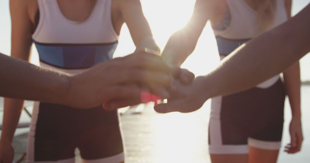 Rowing Team Joining Hands Before Race at Sunset - Free Images, Stock Photos and Pictures on Pikwizard.com