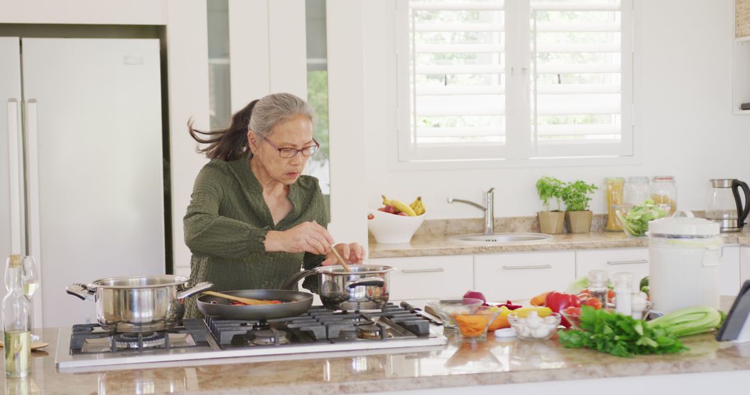 Senior Woman Cooking in Modern Kitchen Using Tablet - Free Images, Stock Photos and Pictures on Pikwizard.com